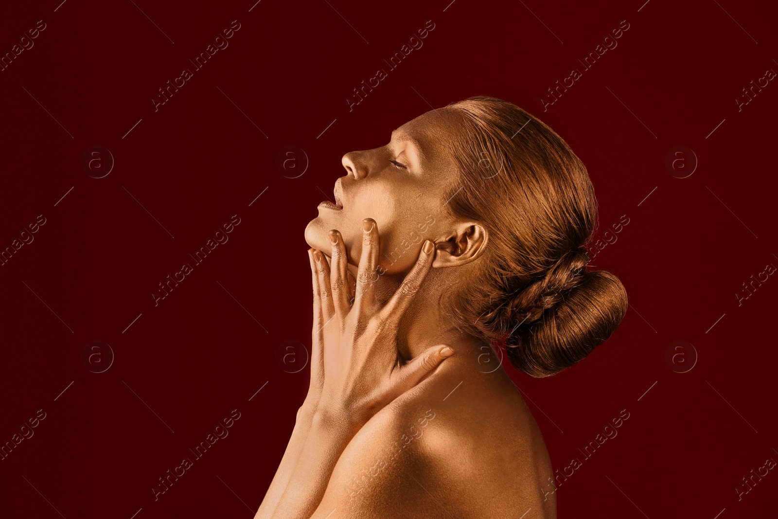 Photo of Portrait of beautiful lady with gold paint on skin against color background