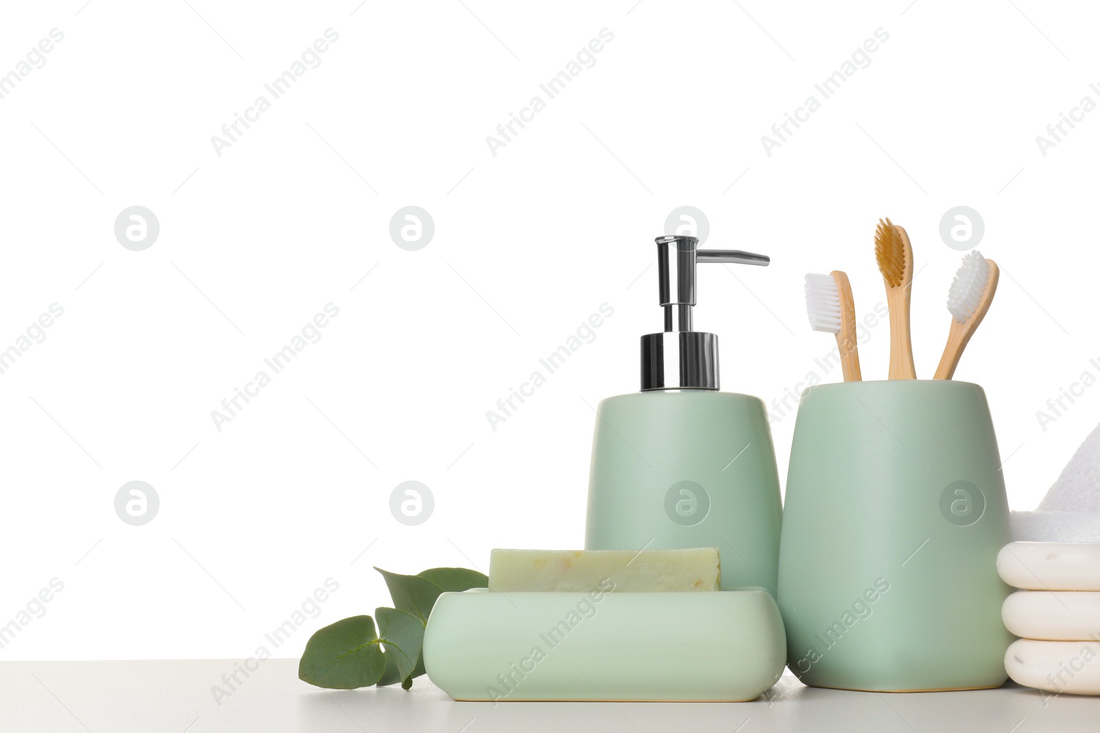 Photo of Bath accessories. Different personal care products and eucalyptus branch on table against white background. Space for text