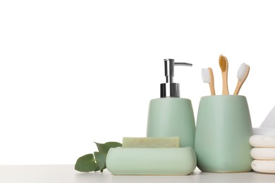 Photo of Bath accessories. Different personal care products and eucalyptus branch on table against white background. Space for text