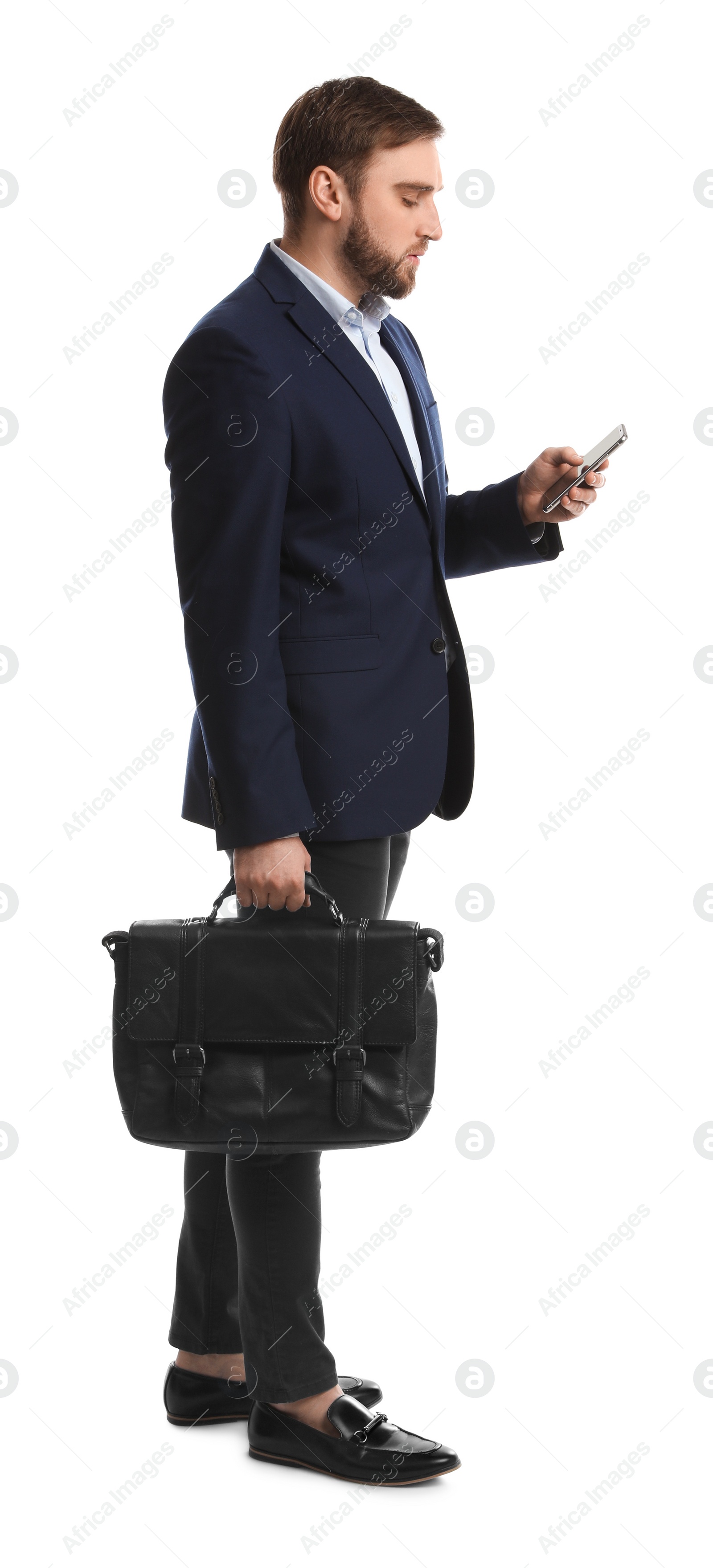 Photo of Young man in business attire with bag and mobile phone on white background
