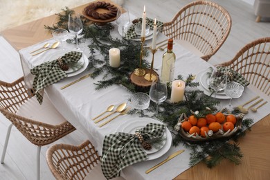 Christmas table setting with festive decor and dishware indoors