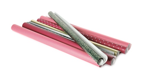 Photo of Different colorful wrapping paper rolls on white background