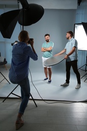 Professional team working with model in photo studio