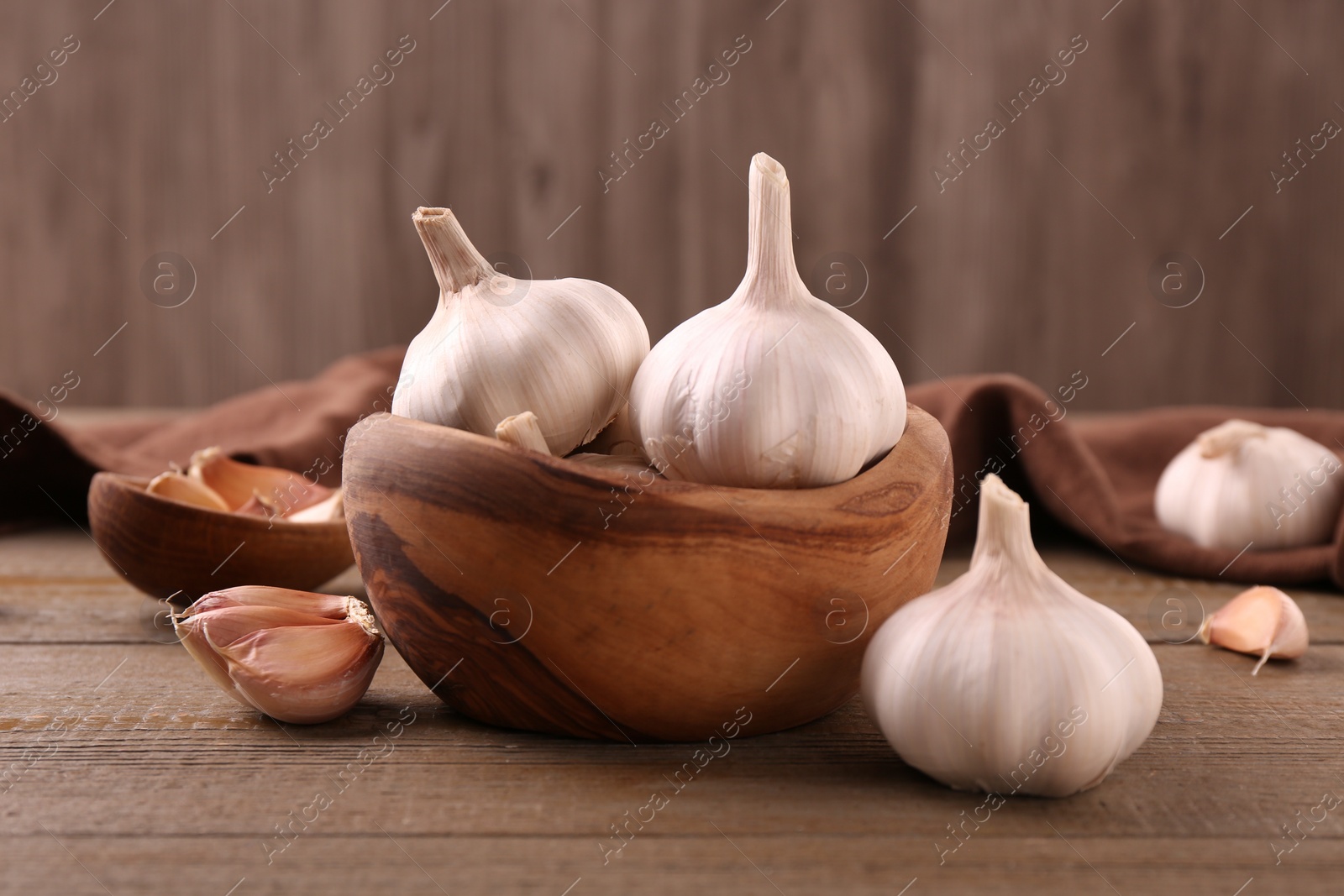 Photo of Fresh garlic on wooden table, closeup view