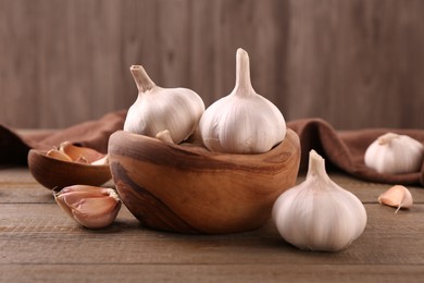 Photo of Fresh garlic on wooden table, closeup view