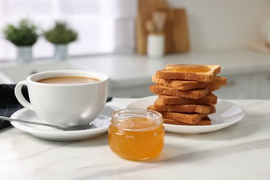 Photo of Breakfast served in kitchen. Fresh toasts, coffee and honey on white marble table