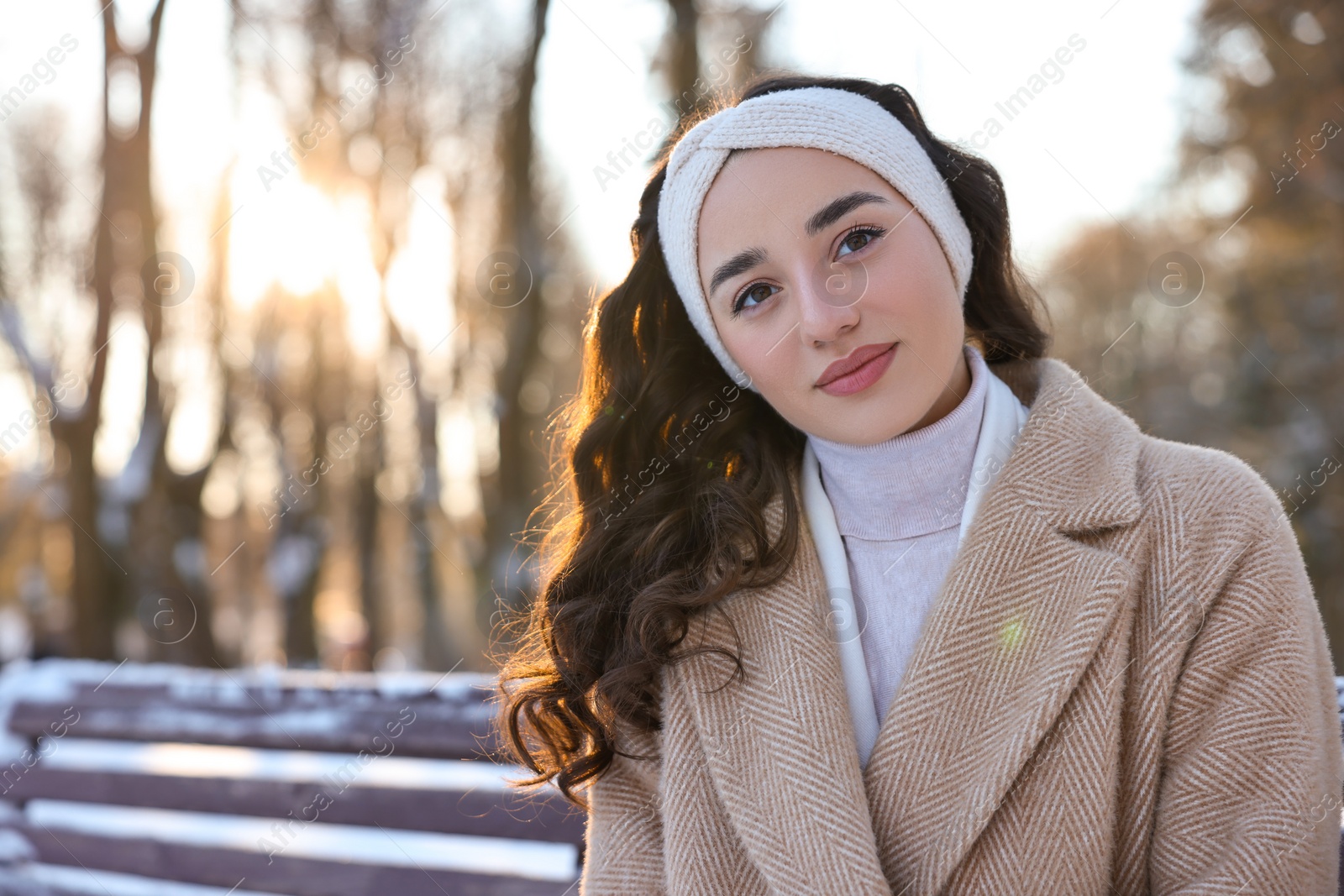 Photo of Portrait of beautiful woman in snowy park. Space for text