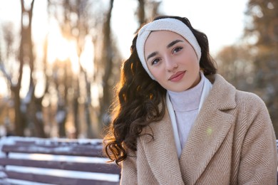 Photo of Portrait of beautiful woman in snowy park. Space for text