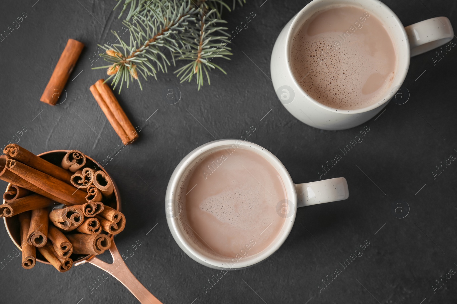 Photo of Flat lay composition with delicious hot cocoa drink on black background