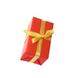 Photo of Orange gift box with yellow bow isolated on white