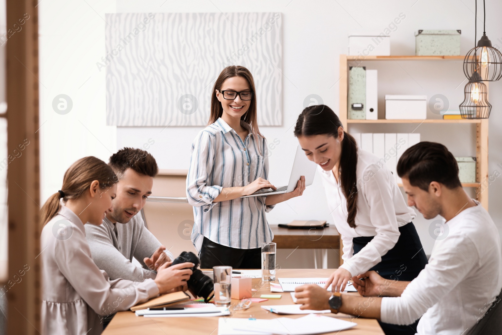 Photo of Team of professional journalists working in office