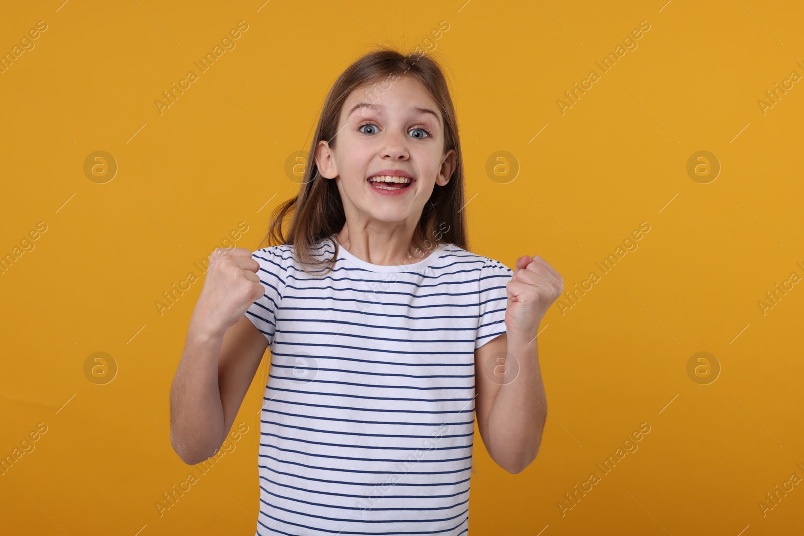 Photo of Portrait of surprised girl on yellow background