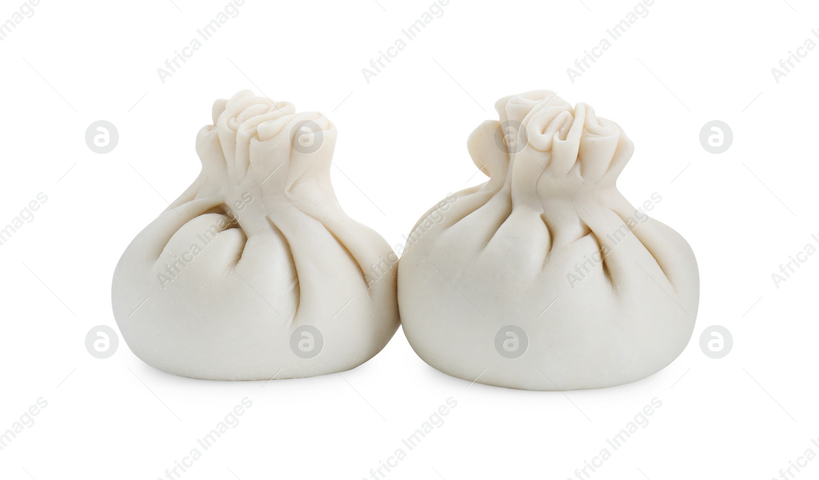 Photo of Uncooked khinkali (dumplings) isolated on white. Georgian cuisine