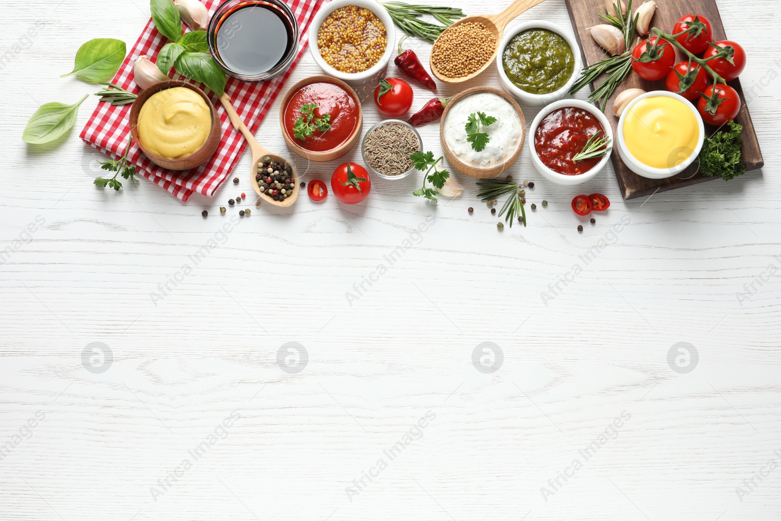 Photo of Flat lay composition with different sauces and space for text on white wooden background