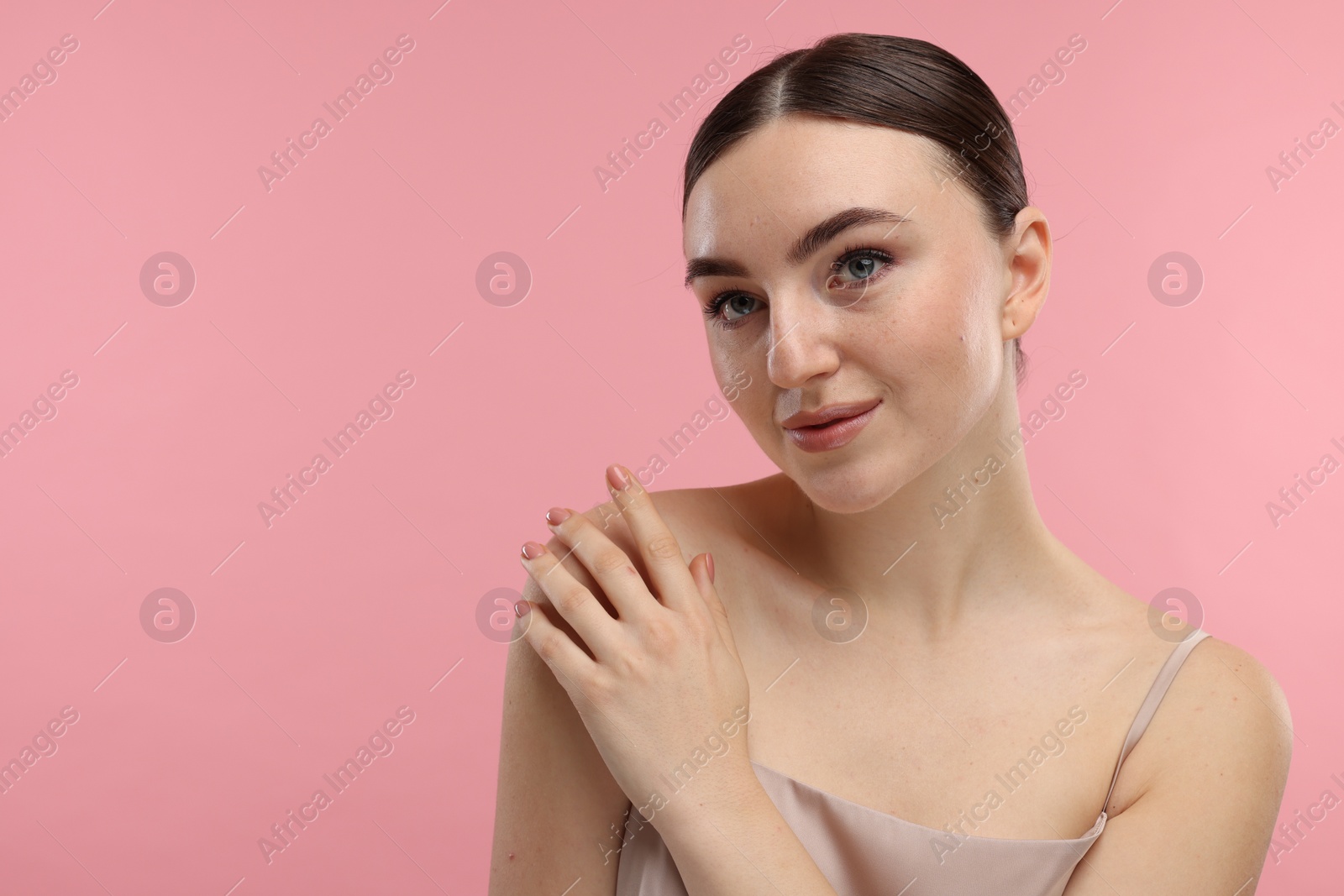 Photo of Portrait of beautiful woman on pink background. Space for text