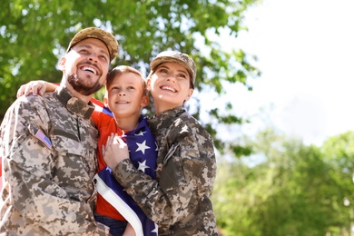 Photo of Happy military family with their son outdoors