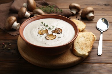 Fresh homemade mushroom soup served on wooden table