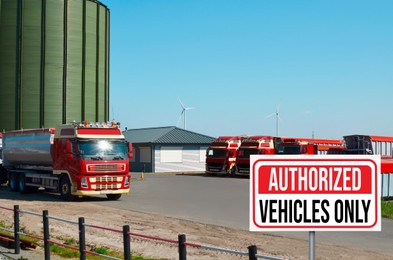 Image of Sign with text Authorized Vehicles Only near granary and parked trucks outdoors
