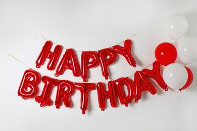 Phrase HAPPY BIRTHDAY made of color balloon letters on white background