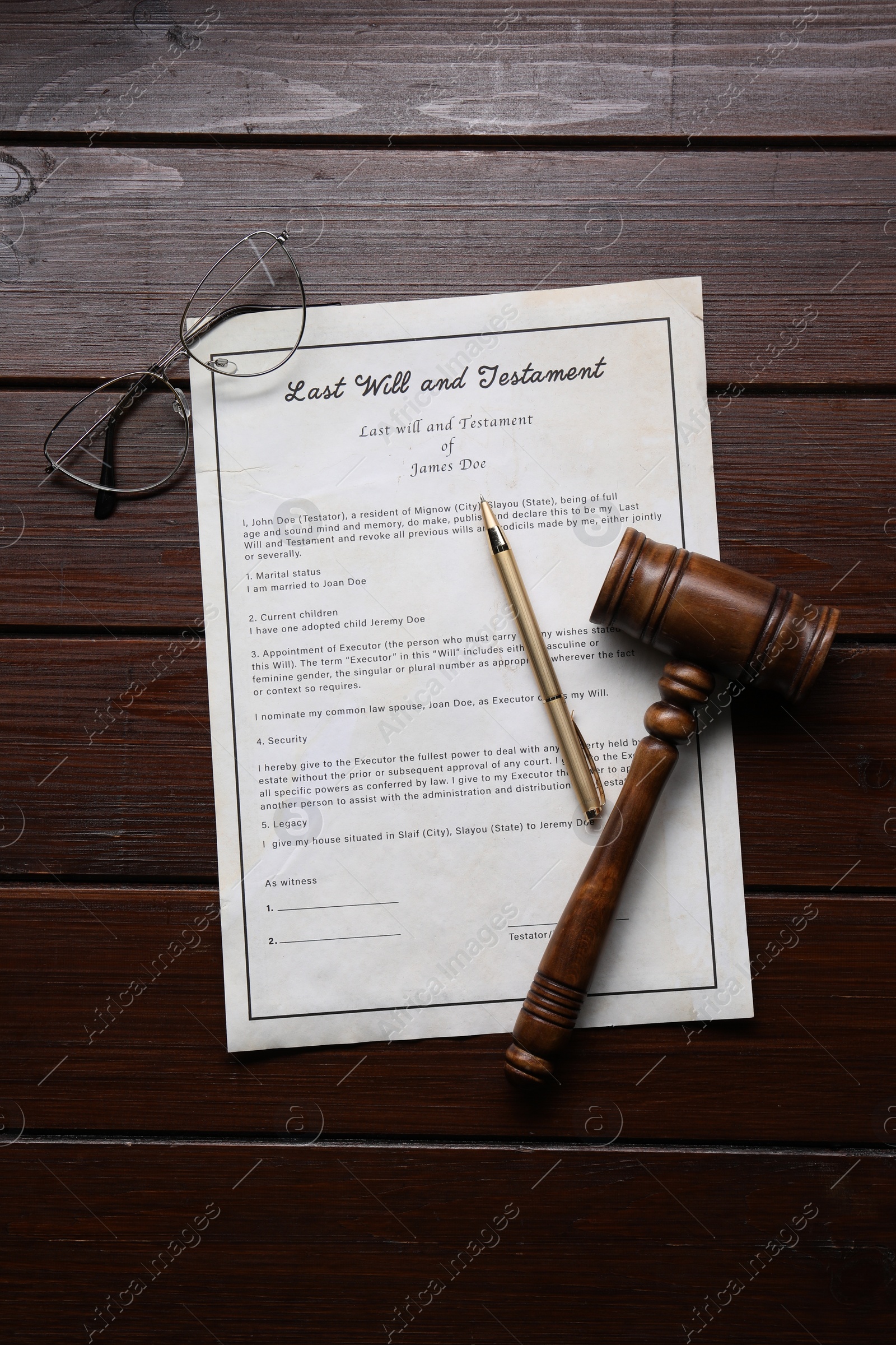 Photo of Last Will and Testament with glasses, gavel and pen on wooden table, flat lay