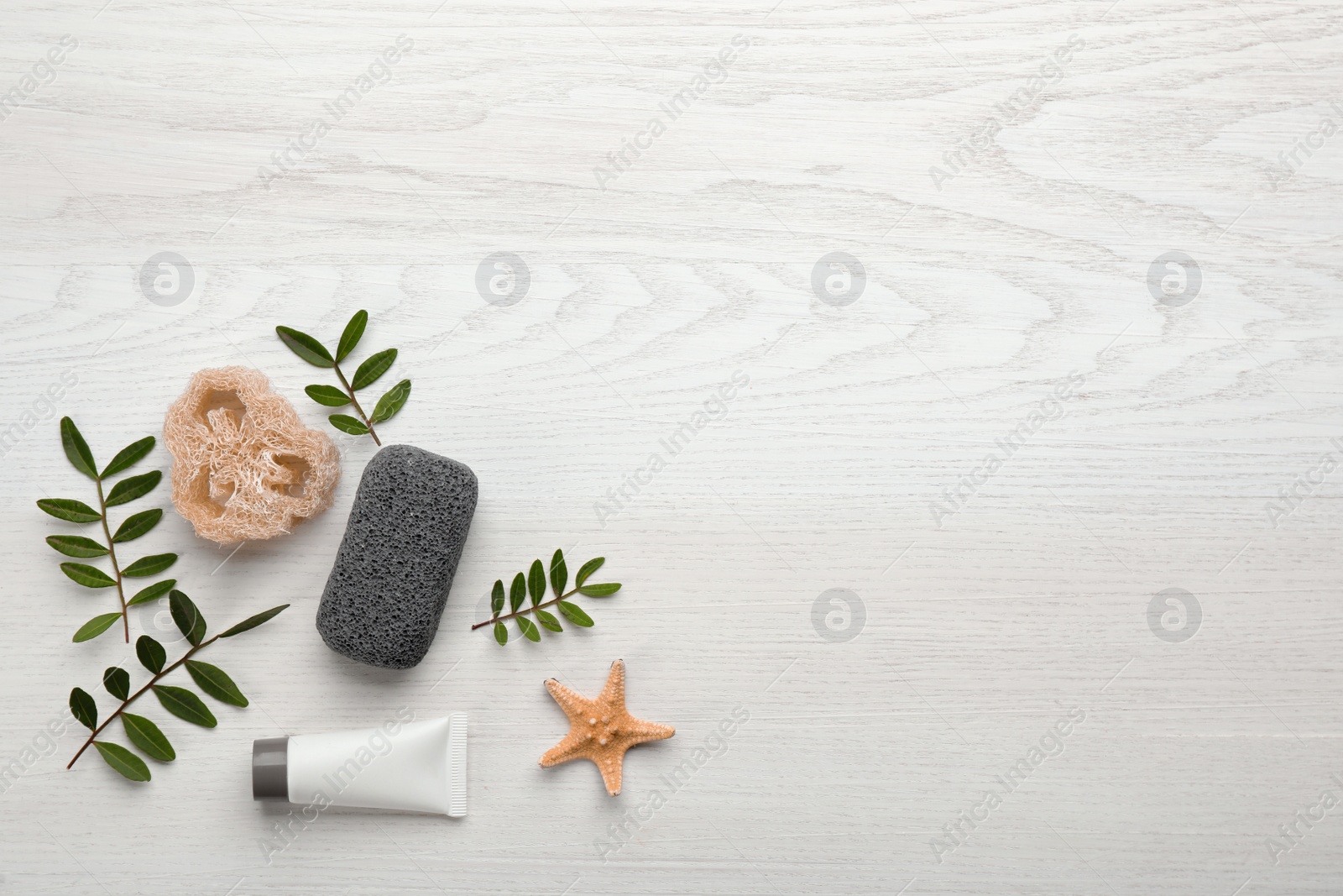 Photo of Flat lay composition with pumice stone on white wooden background. Space for text