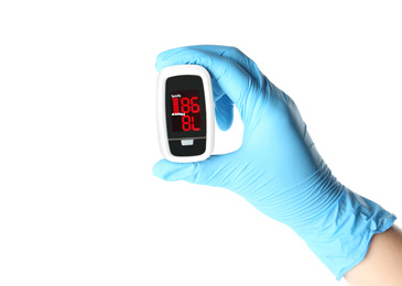 Doctor in latex gloves holding fingertip pulse oximeter on white background, closeup