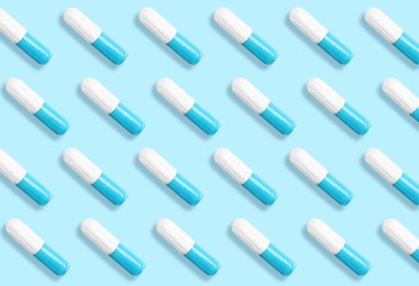Image of Many tampons on light blue background, flat lay 
