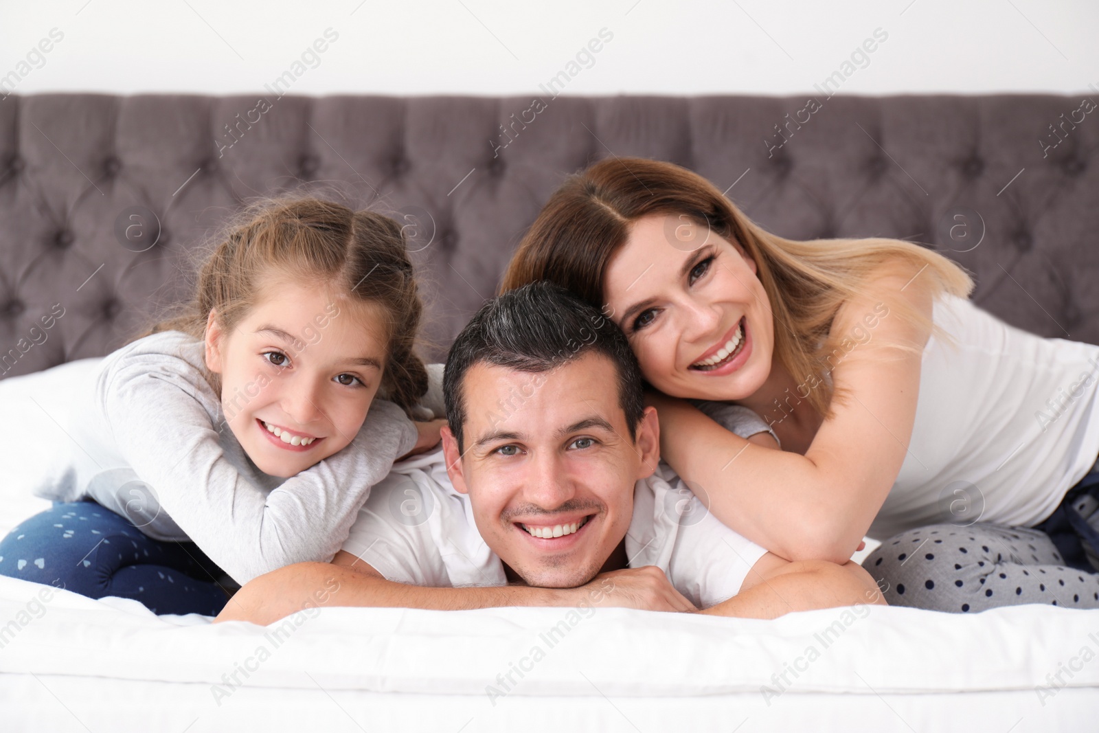 Photo of Happy family with cute child in bedroom