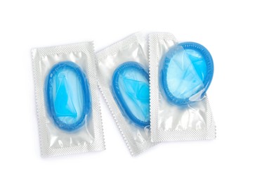 Photo of Condom packages on white background, top view. Safe sex