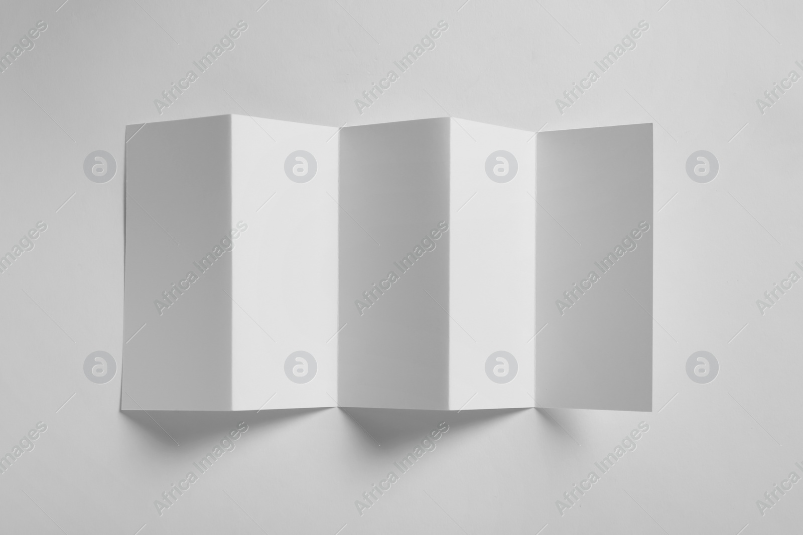 Photo of Blank brochure on white background, above view. Mock up for design