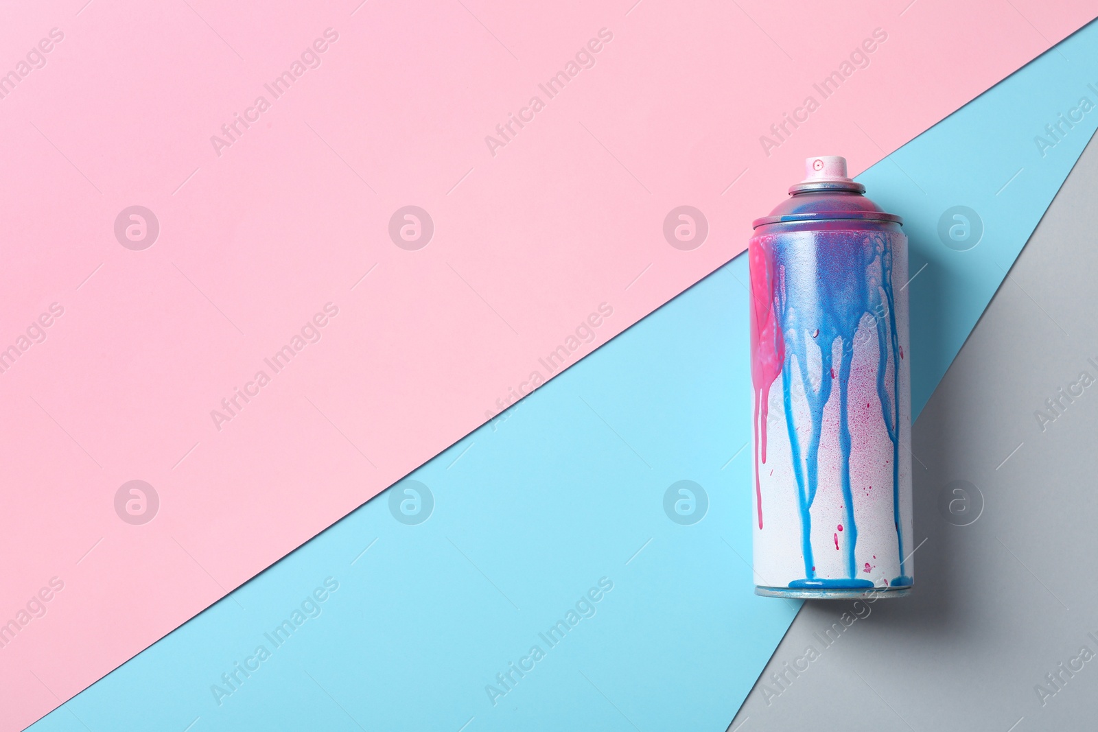 Photo of Used can of spray paint on color background, top view. Space for text