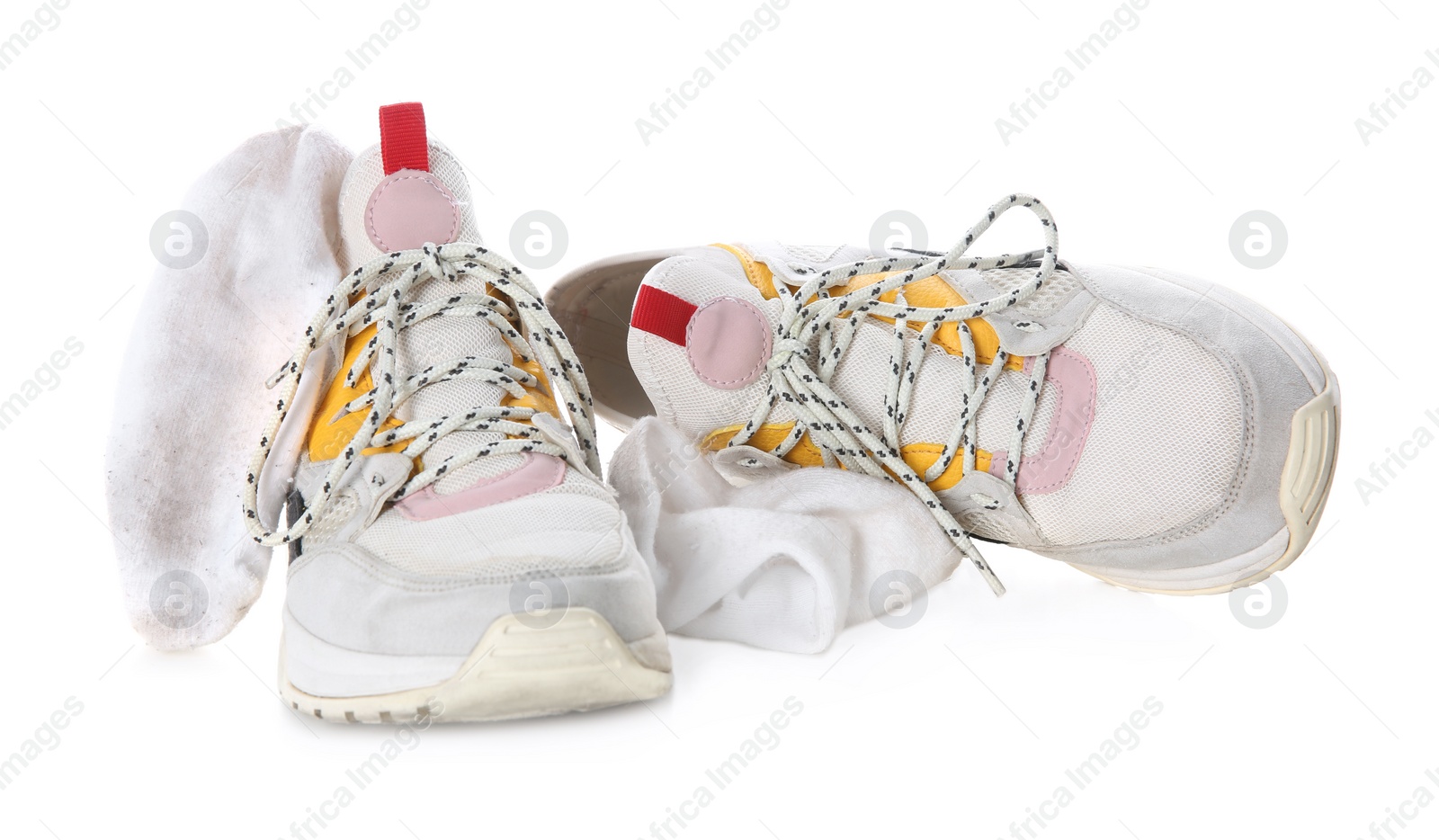 Photo of Sneakers with dirty socks on white background