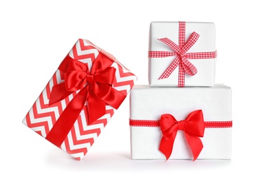 Photo of Beautifully wrapped gift boxes on white background