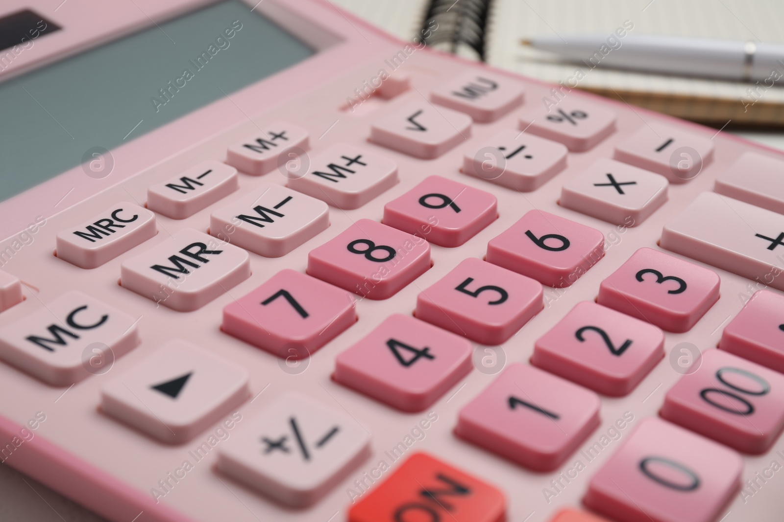 Photo of Closeup view of pink calculator on table