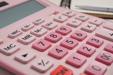 Closeup view of pink calculator on table