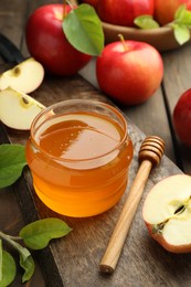 Photo of Sweet honey and fresh apples on wooden table