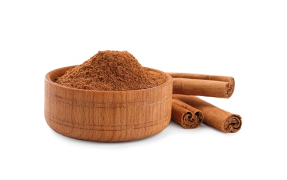 Photo of Aromatic cinnamon sticks and bowl with powder on white background