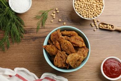 Photo of Flat lay composition with cooked soy meat on wooden table