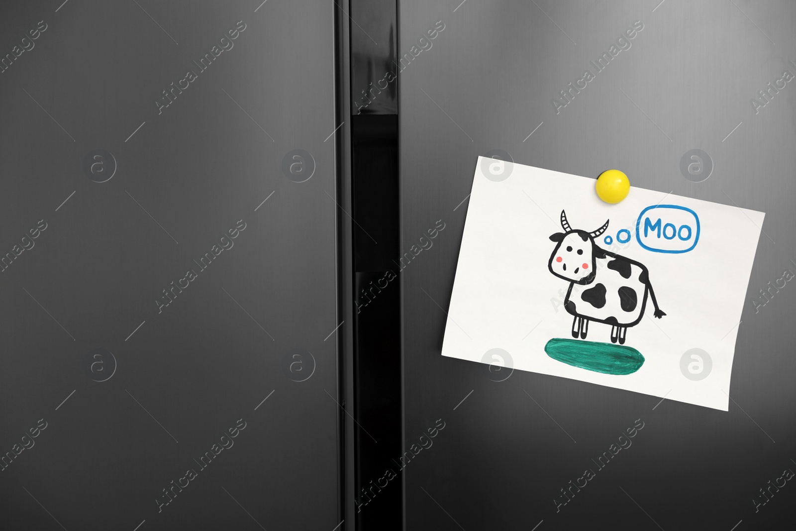 Photo of Modern refrigerator with child's drawing and magnet