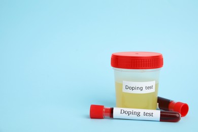 Photo of Jar and test tubes with samples on light blue background, space for text. Doping control