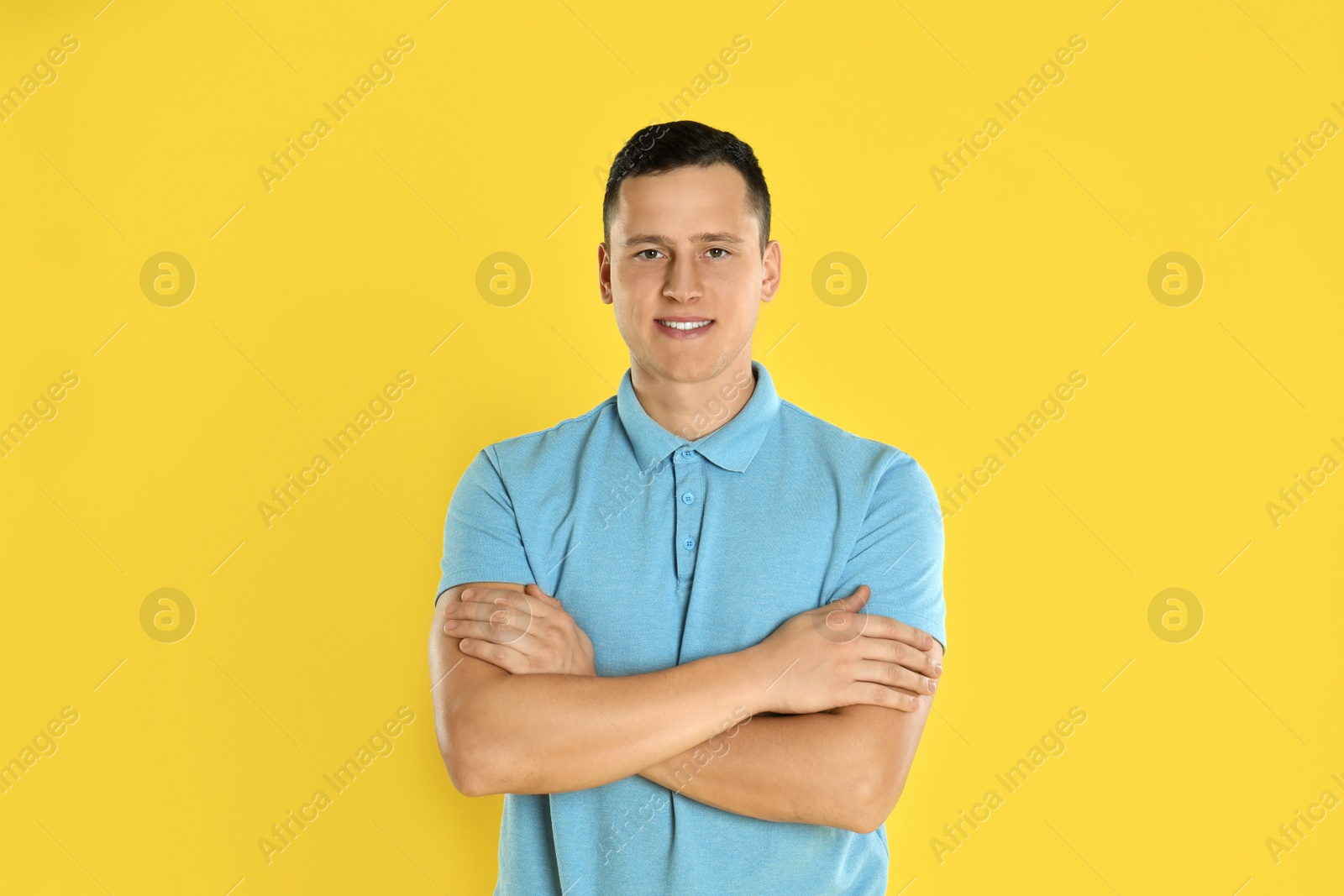 Photo of Happy handsome young man on yellow background