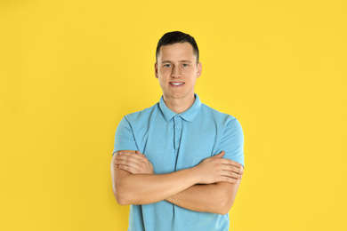 Photo of Happy handsome young man on yellow background