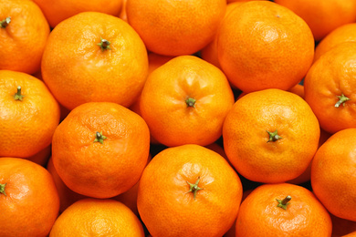 Photo of Delicious fresh ripe tangerines as background, top view