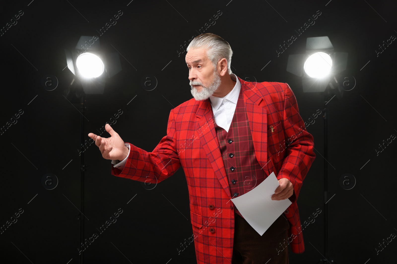 Photo of Senior actor with script performing on stage