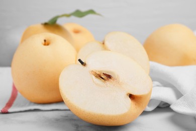 Photo of Delicious apple pears on white marble table, closeup