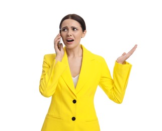 Beautiful emotional businesswoman in yellow suit talking on smartphone against white background