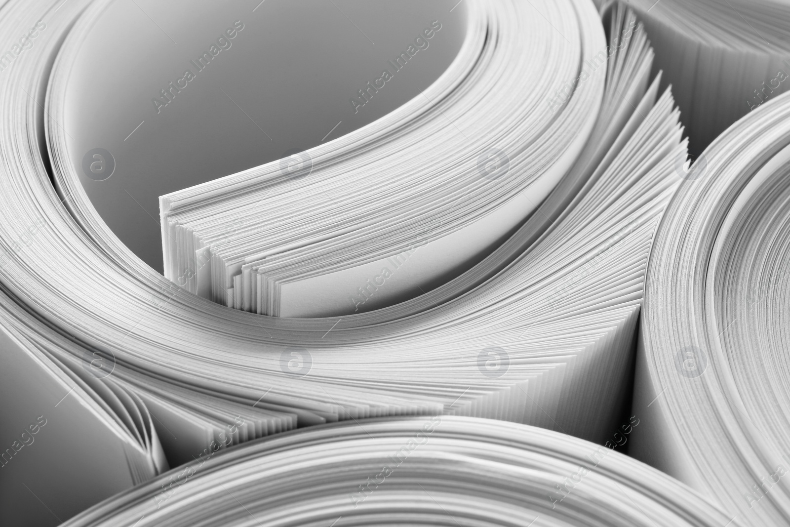 Photo of Rolled white paper sheets as background, closeup