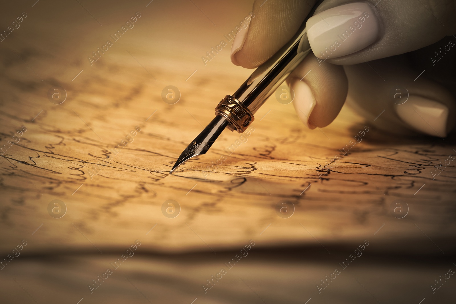 Image of Woman writing letter with fountain pen, closeup