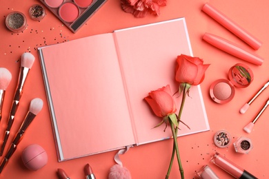 Photo of Flat lay composition with beauty accessories, notebook and roses on coral background. Space for text