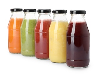 Photo of Bottles of fresh juices on white background